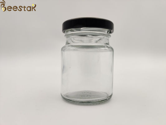kupować 50 ml 75 ml Butelka z gniazdem dla ptaków Okrągły szklany pojemnik na miód Szklane butelki z czarną pokrywką produkcja online
